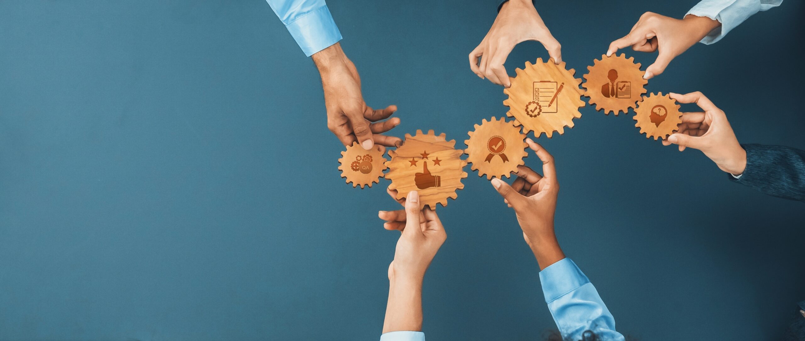 Overhead,View,Of,Diverse,Hands,Interacting,With,Wooden,Gears,That